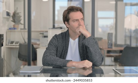 Brainstorming Middle Aged Man Thinking while Sitting in Office