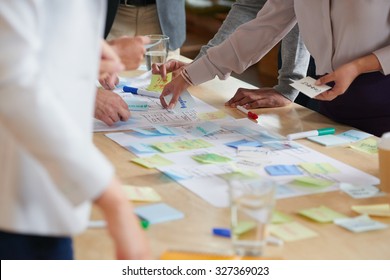 Brainstorming session with post it notes on desk - Shutterstock ID 327369023