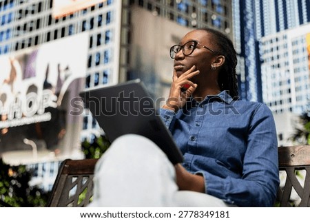Brainstorming, tablet and pensive freelancer working on city park bench. Freelancing, digital touchscreen device and African american teleworker sitting outside, thinking