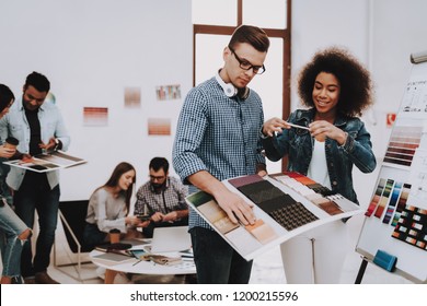 Brainstorming. White Guy. Girl. Color for Design. Multi-Ethnic. Discussion. Talking. Young Specialists. Designers. Work Together. Office. Teamwork. Design Studio. Project. Creative. Workplace. - Powered by Shutterstock