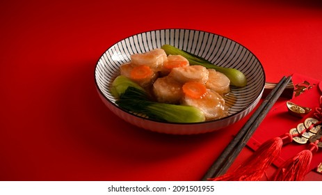 Braise Bean Curd With Oyster Sauce And Vegetable On A Plate And Chopsticks On A Red Dining Table. Chinese Cuisine Concept.