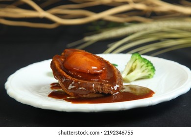 Braised abalone with broccoli and bean curd, premium expensive Chinese delicacy served during dinner celebrations - Shutterstock ID 2192346755