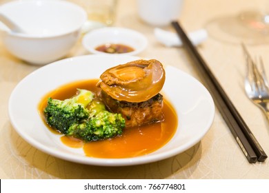 Braised abalone with broccoli and bean curd, premium expensive Chinese delicacy served during dinner celebrations