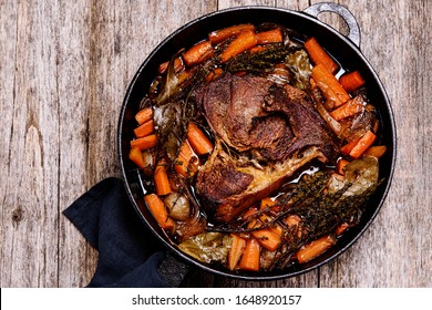 Braised beef brisket big piece with carrots and onion sauce serve in a hot pan