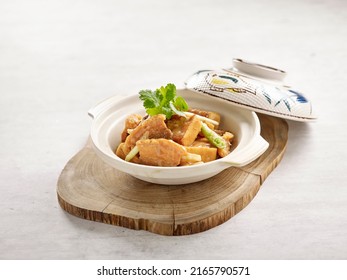 Braised Claypot Tofu With Pork Belly In Prawn Paste Served In A Dish Isolated On Wooden Board Side View On Grey Background