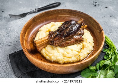 Braised Lamb Shank On The Mashed Potato In A Plate. Gray Background. Top View.