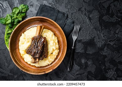 Braised Lamb Shank On The Mashed Potato In A Plate. Black Background. Top View. Copy Space.