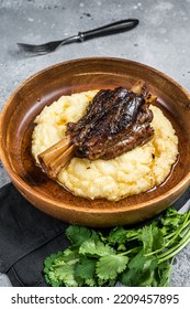 Braised Lamb Shank On The Mashed Potato In A Plate. Gray Background. Top View.