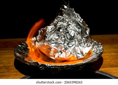 A Braised Pork Ribs In Tin Foil Fired With Alcohol