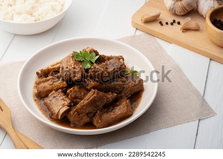 Braised pork spare ribs with soy sauce in white plate