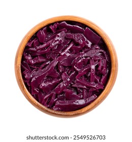 Braised red cabbage in a wooden bowl. Traditional German side dish of intense purple color, made of sliced cabbage, apple, wine vinegar. Simmered slowly and cooked with spices in Christmas time. - Powered by Shutterstock