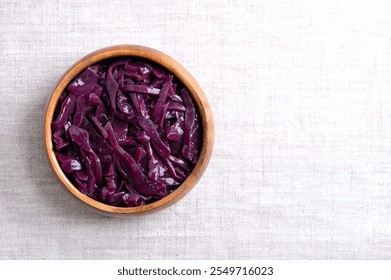 Braised red cabbage in a wooden bowl, with empty space for text. Traditional German side dish of intense purple color made of sliced cabbage, simmered slowly, and in Christmas time cooked with spices. - Powered by Shutterstock