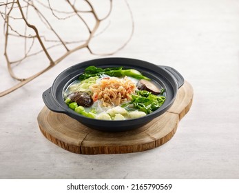 Braised Vegetable And Conpoy With Vermicelli In Fish Soup Served In Casserole Served In A Dish Isolated On Wooden Board Side View On Grey Background