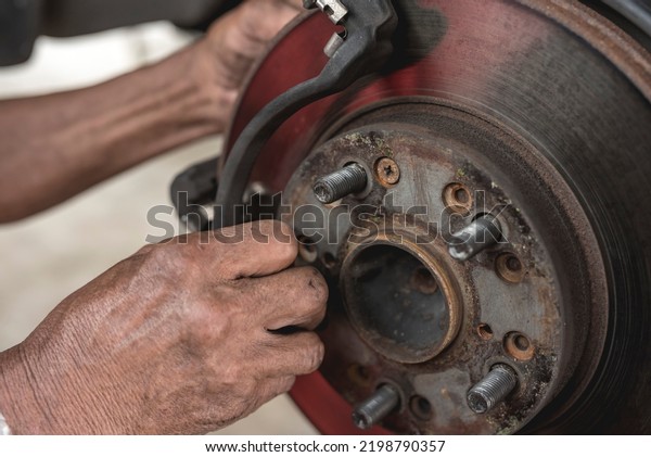 The brake drum
of the front axle of a car lifted above the ground with the disc
caliper and brake pads
removed.