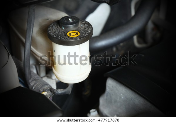 Brake fluid container\
bottle in the car engine represent the car part background concept\
related idea.
