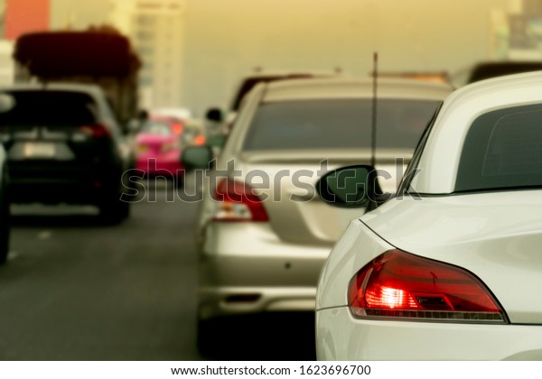 Brake light of luxury  car stop on the\
highway. During the evening traffic in\
city.