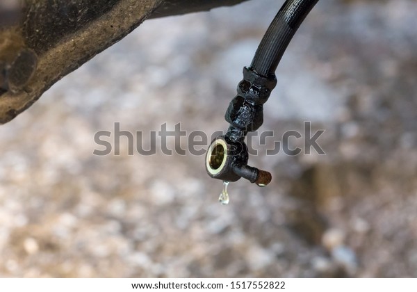 Brake line hose with\
dripping brake fluid