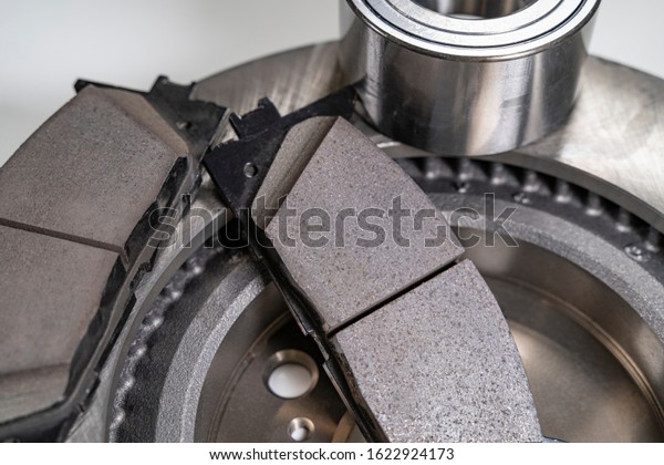 brake pads and auto\
parts on a white table