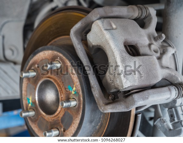 Brake system of car, Closeup disc brake of the\
vehicle for repair in\
garage