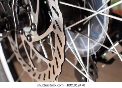 The brake system in a modern sports bike, brake disc and brake caliper with brake pads, background, copy space, macro