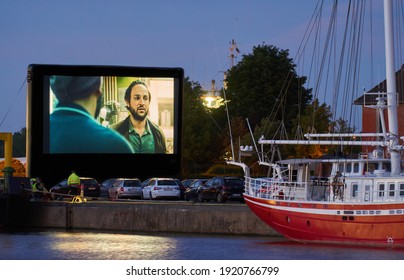 Brake Unterweser, Germany - May 30, 2020: during the covid-19 pandemic, a drive-in movie theater is held at the inland port - the movies are shown on a giant inflatable screen