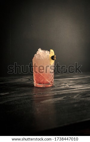 Bramble in an Old fashioned glass in black backdrop