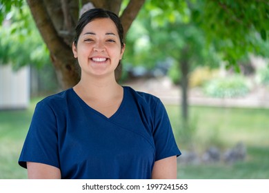 Brampton, ON Canada - June 22 2021: Beautiful, Female, Essential, Front Line Home Worker Smiling. Long-term Personal Health Care Worker Wearing Navy Blue Medical Scrubs In Brampton, Ontario Canada.