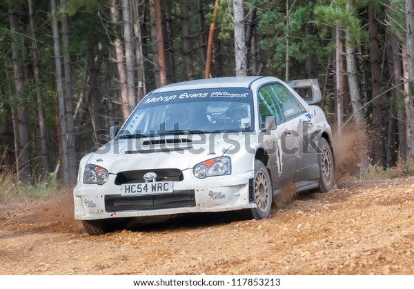 BRAMSHILL FOREST, UK -\
NOVEMBER 3, 2012: John Lloyd driving a WRC spec Subaru Impreza on\
the Warren stage of the MSA Tempest Rally in Bramshill Forest, UK\
on November 3, 2012