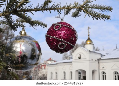 A branch of a Christmas tree with decorations on the background of an Orthodox cross with a crucifix. Orthodox Church. Winter - Christmas, New Year. The concept of Orthodoxy. - Powered by Shutterstock