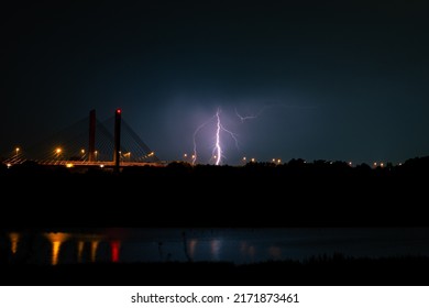 Branched Lightning Bolt Strikes Behind A Cable-stayed Bridge Over River Waal At Night