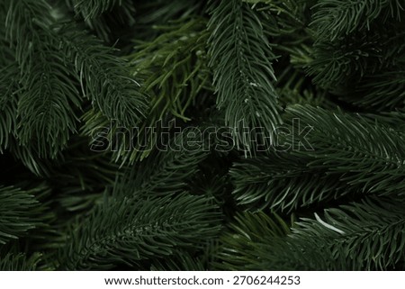 Branches of artificial Christmas tree as background, macro view