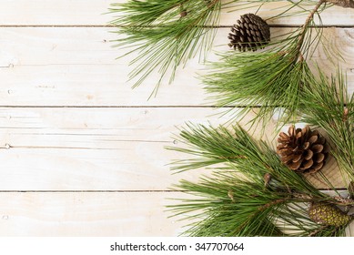 Branches Of Pinetree With Cones On Wooden Background