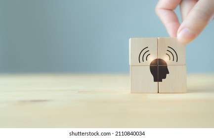 Brand awareness concept. Creating customer awareness. Social media marketing. Initiative marketing funnel. Hand putting the wooden cubes with personal awareness icon on grey background and copy space.