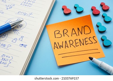 Brand awareness inscription and notebook with marks. - Shutterstock ID 2103769157
