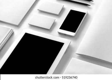 Brand identity mockup. Blank corporate stationery and gadgets set at white textured paper background.