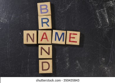 Brand Name Crossword With Wooden Block On The Blackboard