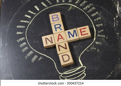 Brand Name Crossword With Wooden Block On The Blackboard
