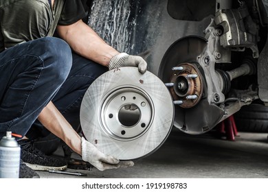 Brand new brake discs for garage cars. Auto mechanic,in process of new tire replacement, Car brake repairing in garage	 - Shutterstock ID 1919198783