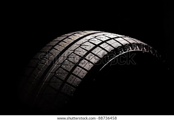Brand new\
car tyre. Isolated on a white\
backgrond.