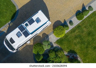 Brand New Class B Camper Van With Solar Panels Installed On Residential Driveway. New Recreational Vehicle Purchase Theme.