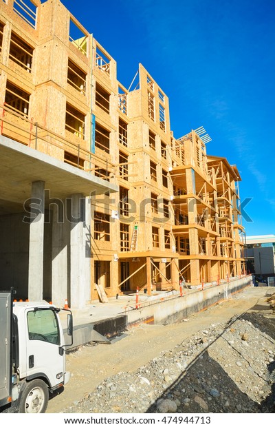 Brand new low-rise building under\
construction on sunny day in British Columbia,\
Canada