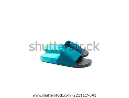 Brand new a pair of blue slide sandals for men with faux-leather upper, comfortable foam lining and contoured foot bed isolated on white background. Slippers with foam outsole cushion