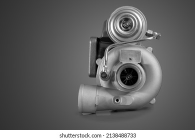Brand new turbo charger or automotive turbine, vintage type or style, smaller turbo, isolated on orange background. View of impeler.