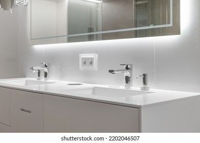 Brand New Water Taps And Double Sink In Luxury Bathroom. Modern Mirror With Lightning.