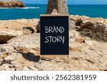 Brand story branding symbol. Concept words Brand story on beautiful yellow chalk blackboard. Beautiful stone beach blue sky sea background. Business brand story branding concept. Copy space.