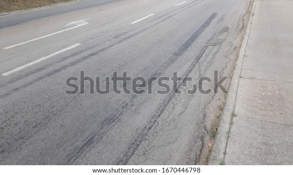brand of
tire brake on asphalt road surface
background