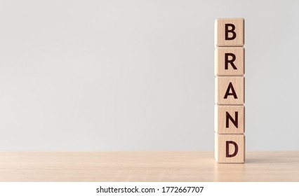 Brand Word Written On Wood Block On Wooden Background.