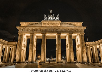 Brandenburg Gate in Berlin, Germany, light up at night casting long shadows from the east side - Front on - Powered by Shutterstock