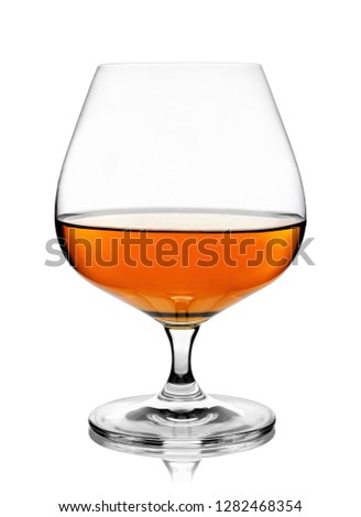 brandy or cognac in snifter glass isolated on white background with clipping path