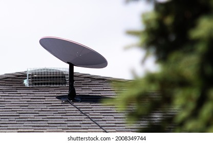 BRANT, CANADA - June 21, 2021: A SpaceX Starlink satellite internet receiver seen installed on the roof of a home in a rural Canadian community. 